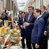 Deputy Prime Minister and Minister of Foreign Affairs Bui Thanh Son visits a Vietnamese booth at the event. (Photo: VNA)