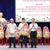 Pham Minh Tuan (first right) , Vice Chairman of the VFF Committee of HCM City, hands over presents to the representative board of the Muslim community in the city. (Photo: VNA)