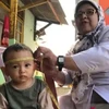 A health worker carries out measurements on toddlers at Posyandu Cibatu in South Cikarang, Bekasi District, West Java, Indonesia. (Photo: Antara)