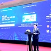 越南工贸部副部长阮生日新在16日工贸部举行的2024年越南国家品牌国际论坛上发表讲话。图自Vietnam+