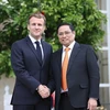 Le Premier ministre Pham Minh Chinh rencontre le président français Emmanuel Macron, lors de sa visite officielle en France en novembre 2021. Photo: VNA