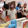 Students visit a booth at the festival. (Photo: VNA)