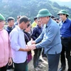 Politburo member, Chairman of the Party Central Committee's Information and Education Commission Nguyen Trong Nghia presents gifts to residents in Ngoc Chien commune, Muong La district, Son La province. (Photo: VNA)