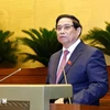 Prime Minister Pham Minh Chinh delivers a report at the ongoing 8th session of the 15th National Assembly in Hanoi on October 21. (Photo: VNA)