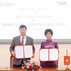 General Director of the Vietnam News Agency Vu Viet Trang (right), and President and CEO of the Republic of Korea (RoK)’s Yonhap News Agency Hwang Dae-il sign the minutes of their talks in Hanoi on December 10. (Photo: VNA)