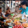 Distribute leaflets and popularise social insurance policies to people in Nam Dinh city. (Photo: VNA) 