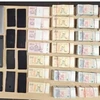 Cash and gambling paraphernalia seized during a transnational unlawful betting cracking operation by the Singaporean and Malaysian police. (Photo: channelnewsasia.com) 