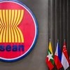 The ASEAN logo seen outside a building next to the flags of some of its members, in this file photo. — (Photo: BERNAMA)