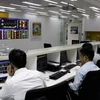 Traders work on a floor of a securities firm in HCM City. (Photo: VNA) 