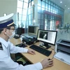 An official from the International Health Quarantine Centre in Lang Son province use equipment to support health quarantine efforts at the Huu Nghiị International Border Gate. (Photo: VNA) 