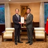 Governor of Fukushima Uchibori Masao (left) symbolically presents the donation to Vietnamese Ambassador Pham Quang Hieu on October 17. (Photo: VNA)