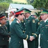 General Phan Van Giang, Deputy Secretary of the Central Military Commission and Minister of National Defence, and Lao Deputy Prime Minister and Minister of National Defence General Chansamone Chanyalath greets military officials at the second Vietnam-Laos border defence friendship exchange on October 22 (Photo: VNA)