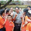 El primer ministro de Vietnam, Pham Minh Chinh y los niños discapacitados en el Centro de Amparo de Menores con Discapacidad en Hanoi (Fuente: VNA)