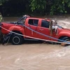 The pickup truck drove through the flooded road, and swept into a swollen roadside creek. (Photo: Cebudailynews)