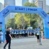 Around 500 people join in a five-kilometre run or walk and several “green action” events to kick off the week. (Photo: VNA)