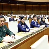 Most of the deputies present at the 15th NA's 8th sitting voting in favour of the law on amending and supplementing several articles of the Law on Officers of the Vietnam People's Army (Photo: VNA)