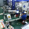 芹苴市忠安高技术农业股份公司大米加工厂的出口大米包装线。图自越通社