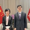 中国香港特区政府行政长官李家超和越南新任驻香港和澳门总领事黎德行。图自越通社