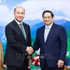 Премьер-министр Фам Минь Тьинь и генеральный секретарь Отдела ЦК НПК по работе с народными массами, вице-премьер Камбоджи Хун Мани. (Фото: ВИА)