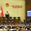 L’Assemblée nationale vote pour adopter la Loi sur le notariat (amendée), à Hanoi, le 26 novembre. Photo: VNA