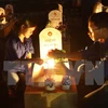 Candles are lit at graves of revolutionaries and soldiers at the Road 9 National Martyrs Cemetery in Quang Tri.