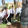 President Truong Tan Sang plants trees at the memorial site. (Photo: VNA)