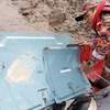 Malaysian air crash: debris, female body found