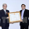 First class order bestowed upon former chief of Vietnam News Agency