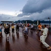 International tourists practice Tai chi aboard their cruise visiting Ha Long Bay. (Photo: VietnamPlus) 