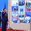 Vietnamese Prime Minister Nguyen Xuan Phuc (left) and Minister of Industry and Trade Tran Tuan Anh, together with leaders of other RCEP member countries, witness the pact signing via videoconference on November 15 (Photo: VNA)