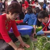 Hanoi children eager to wrap Chung cake as Tet gifts