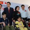 Former Japanese PM presents wheelchairs to Vietnamese disabled 