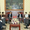Xinhua President visits Nhan Dan newspaper 