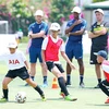 English football coaches train kids in Vietnam