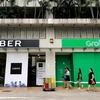 Singapore sets interim measures for Grab-Uber merger