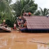 Vietnamese firm tries to take workers out of flooded area in Laos