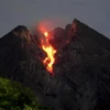 Volcanoes in Indonesia spew incandescent lava, ash column