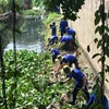 Green Summer volunteers clean up canals, build roads and houses