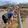 Foreign tourists help clean up Hoi An after typhoon Noru