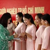 Aid presented to teachers of Lao-Vietnamese bilingual school