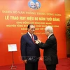 60-year Party membership badge presented to former Party chief Nong Duc Manh