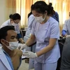 Laos recommends people keep getting COVID-19 vaccination