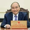 Presidente de Vietnam rinde homenaje a las personas con méritos revolucionarios 