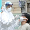 Медицинский работник берёт образец у жителей для тестирования на COVID-19. (Фото: ВИА/Vietnam+)