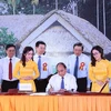 Премьер-министр Нгуен Суан Фук подписывает выпуск специального набора почтовых марок по случаю 130-летия со дня рождения президента Хо Ши Мина. (Фото: ВИА)