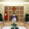 Премьер-министр Нгуен Суан Фук председательствует на заседании руководящего комитета по реструктуризации кредитных организаций 27 июля (Фото: ВИА)