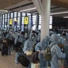Граждане Вьетнама проходят регистрацию в аэропорту (Фото: ВИА)