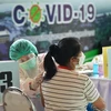 Тайской женщине сделана прививка от COVID-19 (Фото: Синьхуа / ВИА)