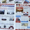 Крупные лаосские газеты торжественно опубликовали на первых полосах новости и статьи об официальном визите во Вьетнам председателя Национального собрания Сайсомфона Фомвихана. (Фото: ВИА)
