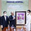 Президент Нгуен Суан Фук (третий слева) вручает портрет президента Хо Ши Мина больнице Дананга. (Фото: ВИА)